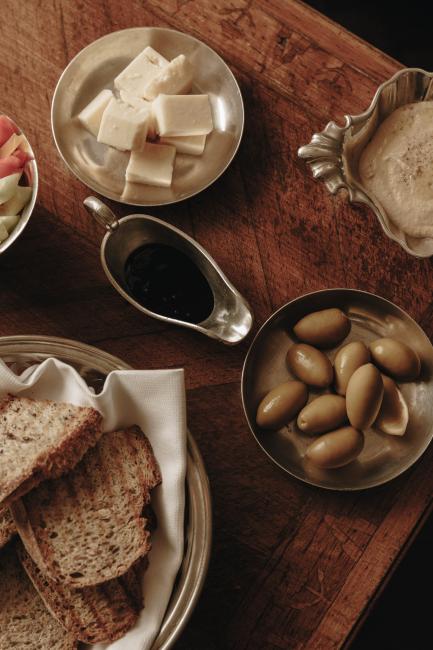 Holztisch auf den Oliven, Brot und Käse stehen